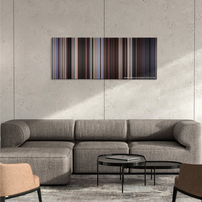 American Beauty color palette canvas on a concrete wall above a gray sectional sofa