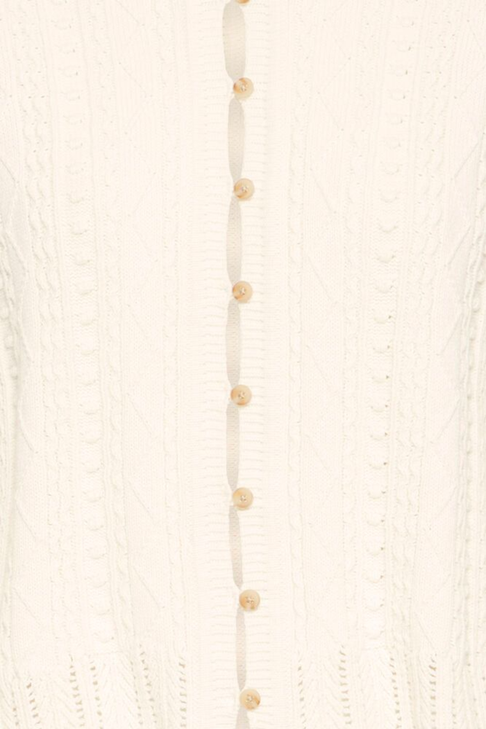 Soft cotton cardigan by Atelier Rêve in a classic birch shade. Easy to layer over dresses and tees for everyday wear. Shop at Dotique.