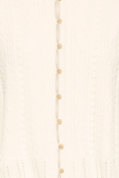 Soft cotton cardigan by Atelier Rêve in a classic birch shade. Easy to layer over dresses and tees for everyday wear. Shop at Dotique.