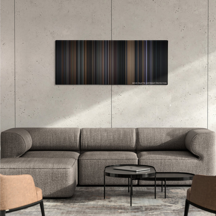Batman color palette canvas on a concrete wall above a gray sectional sofa