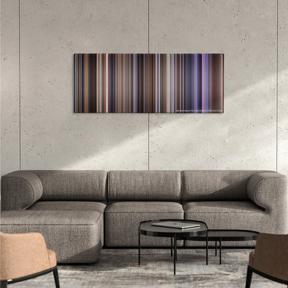 Contact color palette canvas on a concrete wall above a gray sectional sofa