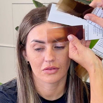 Close up of client face with eyebrow pigment swatch during color selection process