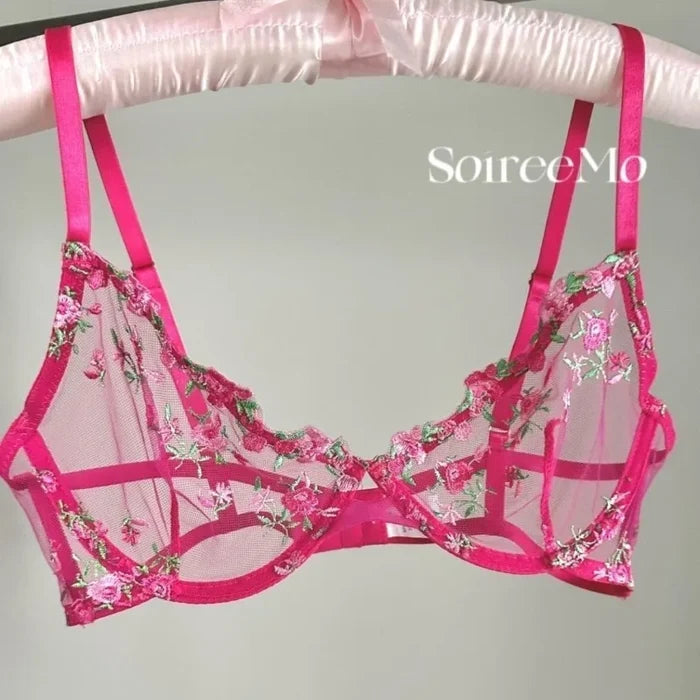 Pink floral bra on a hanger with 'Soiree Mo' branding.