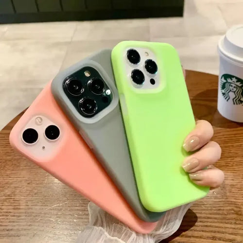 A woman holding a green and pink iphone case