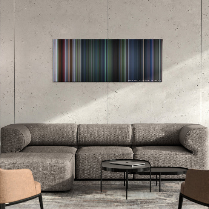 Jurassic Park III color palette canvas on a concrete wall above a gray sectional sofa