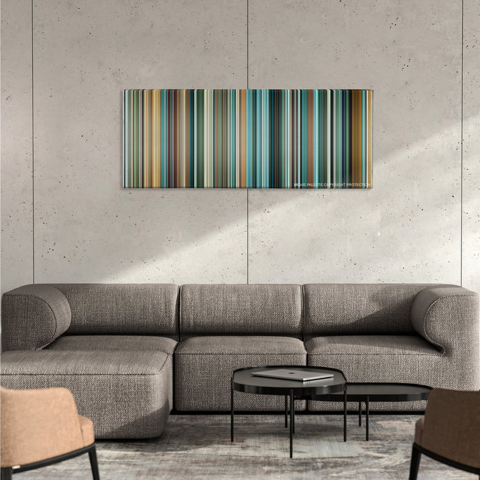 Layer Cake color palette canvas on a concrete wall above a gray sectional sofa