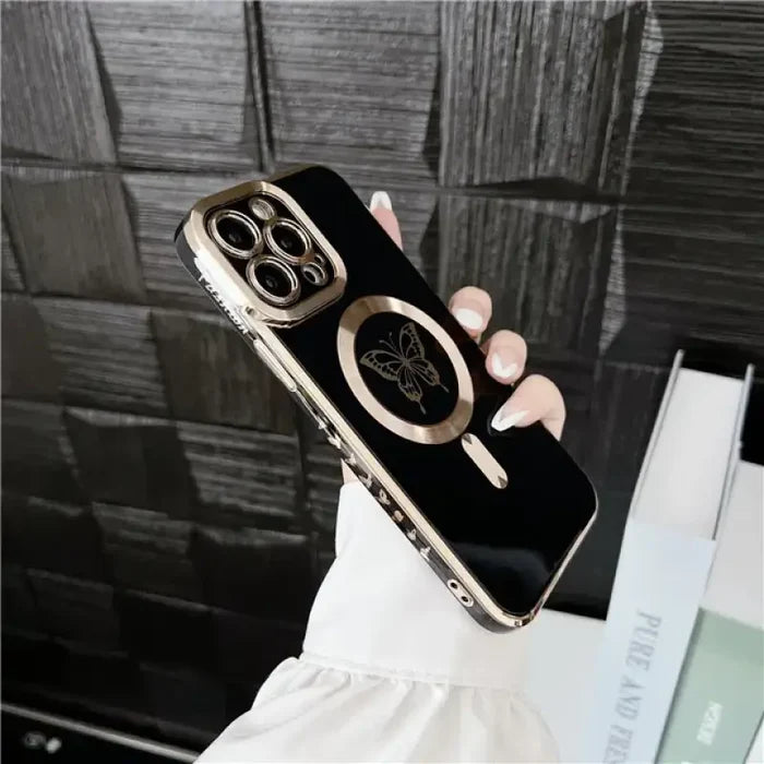 A woman holding a black and gold iphone case
