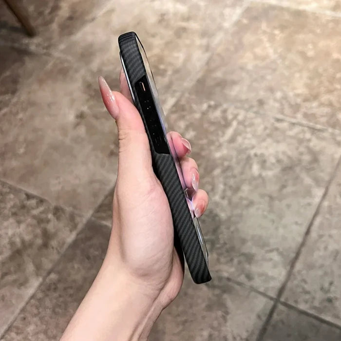Hand holding a black carbon fiber phone case.