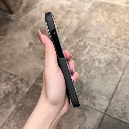Hand holding a black carbon fiber phone case.