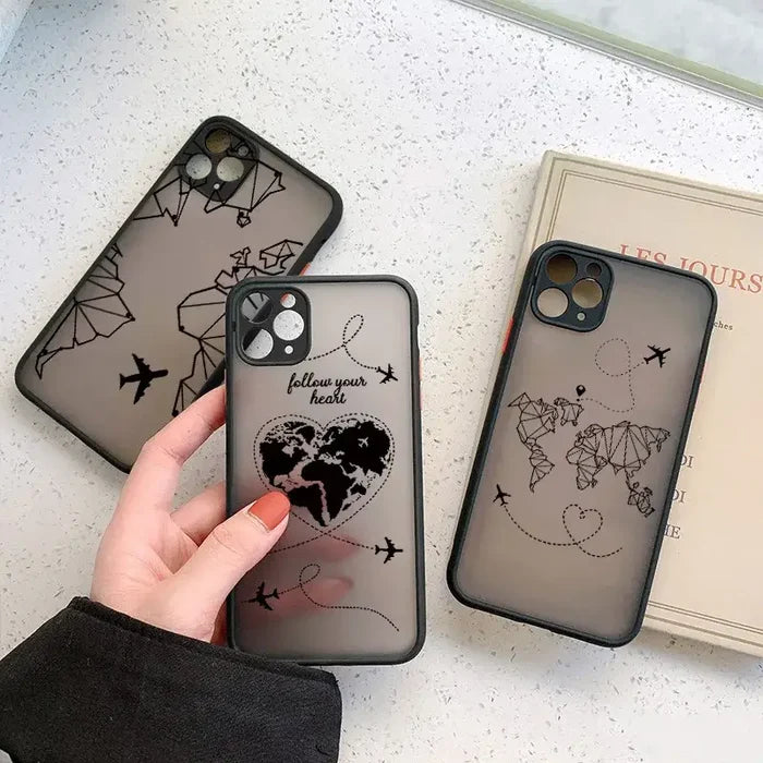 A woman holding a phone case with a world map on it