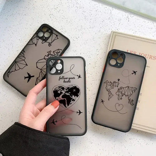 A woman holding a phone case with a world map on it