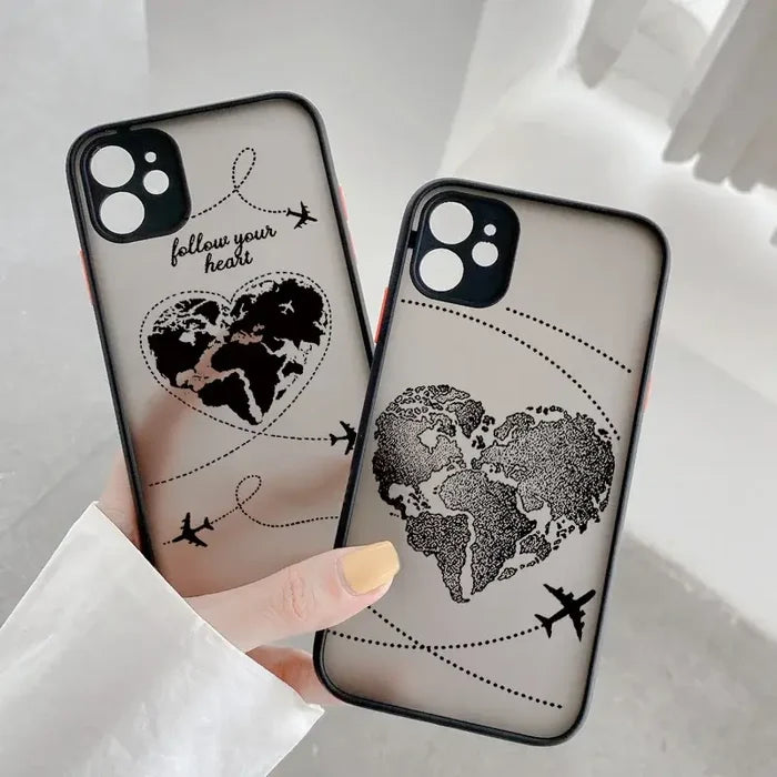 A woman holding a phone case with a world map on it