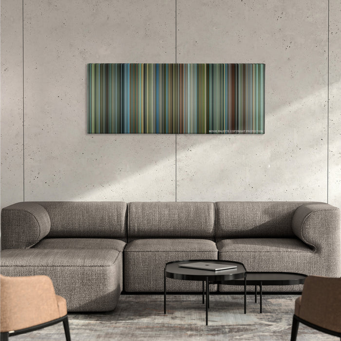 Man on Fire color palette canvas on a concrete wall above a gray sectional sofa