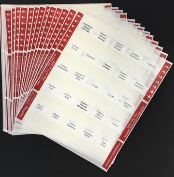 Multiple sheets of preprinted tabs for organizing GITS Trade 1 study materials with red headers on a black surface