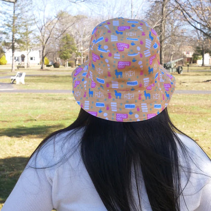 Person wearing a colorful patterned bucket hat outdoors in a park.