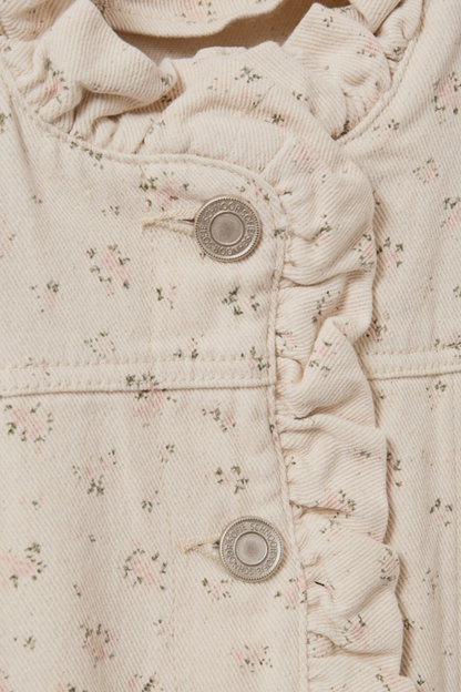Close-up of floral fabric and branded buttons on Sofie Schnoor S261215 Farahsw Frill Sleeve Gilet – Rose Flower, shop Sofie Schnoor at Dotique