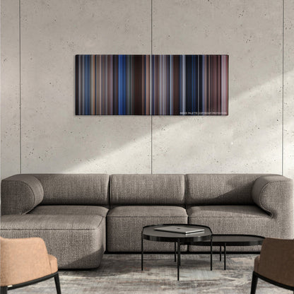 The Bodyguard color palette canvas on a concrete wall above a gray sectional sofa