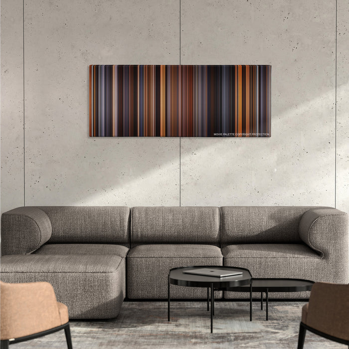 The English Patient color palette canvas on a concrete wall above a gray sectional sofa