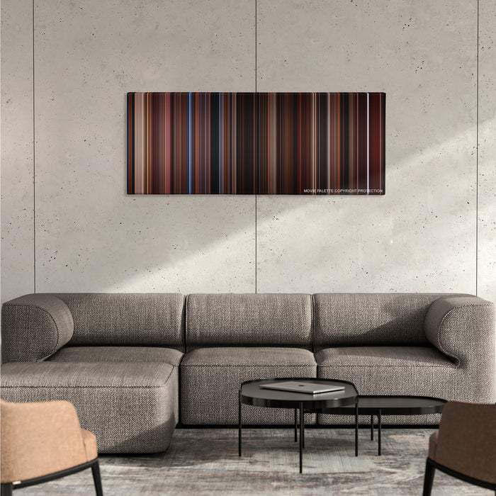 The Lost Boys color palette canvas on a concrete wall above a gray sectional sofa