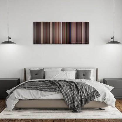 Tootsie color palette canvas above a bed, between two black pendant lamps