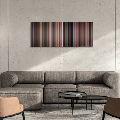 Tootsie color palette canvas on a concrete wall above a gray sectional sofa