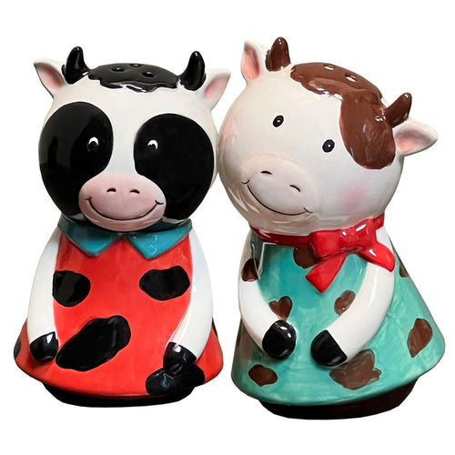 Two cow-themed salt and pepper shakers on a white background