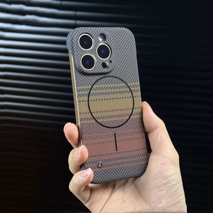 Hand holding a multi-colored, patterned iPhone case with a MagSafe ring.