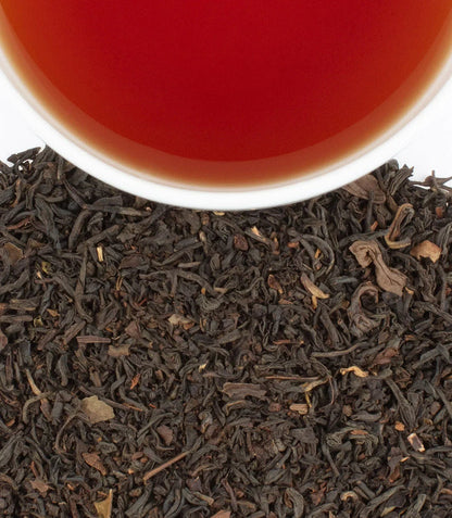 Williamsburg Earl Grey Tea by Harney & Sons — dry blend beside a brewed cup for illustration; cups are separate
