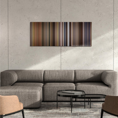 Willow color palette canvas on a concrete wall above a gray sectional sofa